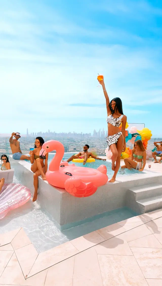 Guests gathering around a rooftop pool at a premium leisure destination